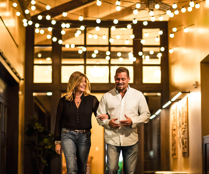 couple walking under lights